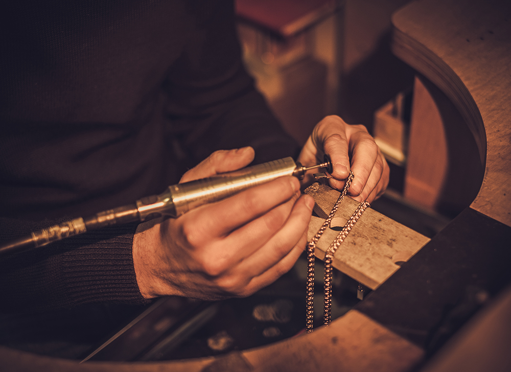 Jeweler at work in jewelery workshop